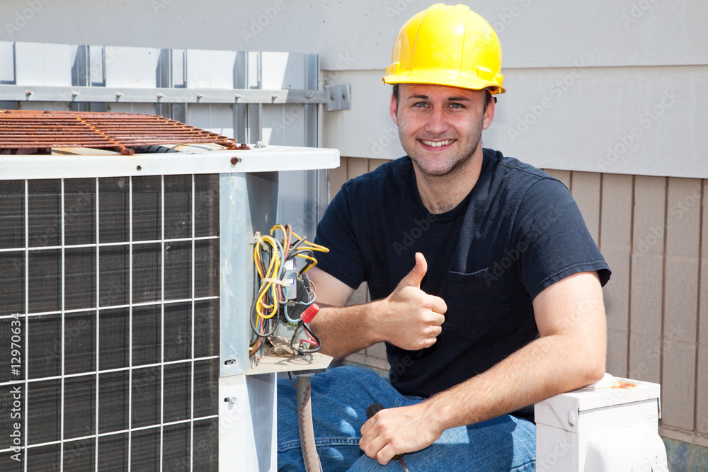 Stock photo of a man repairing heating pump ATD Services